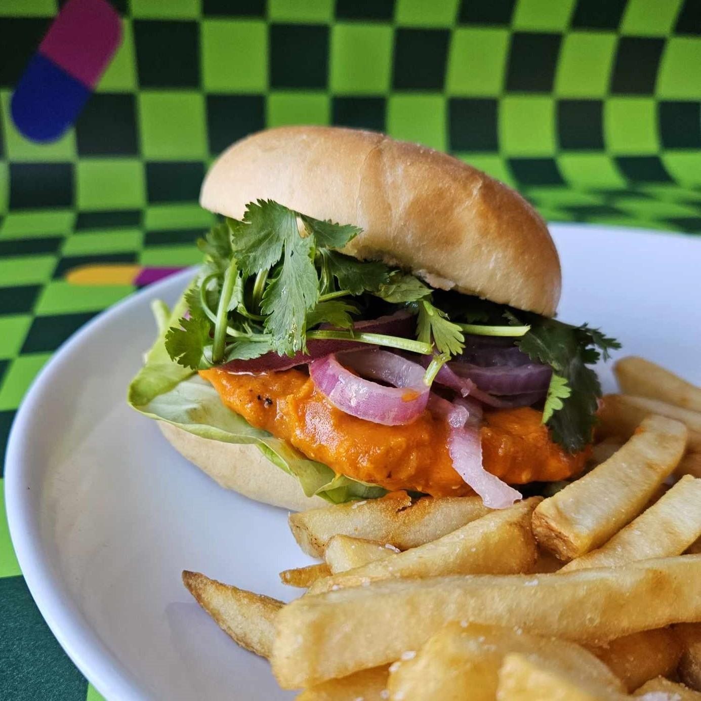 Vegan Chick'n Sandwich - Traditional Roll, Breaded & Fried Vegan Chick'n Patty, Tossed in Garlic Habanero Sauce, Marinated Red Onion, Cilantro, Lettuce