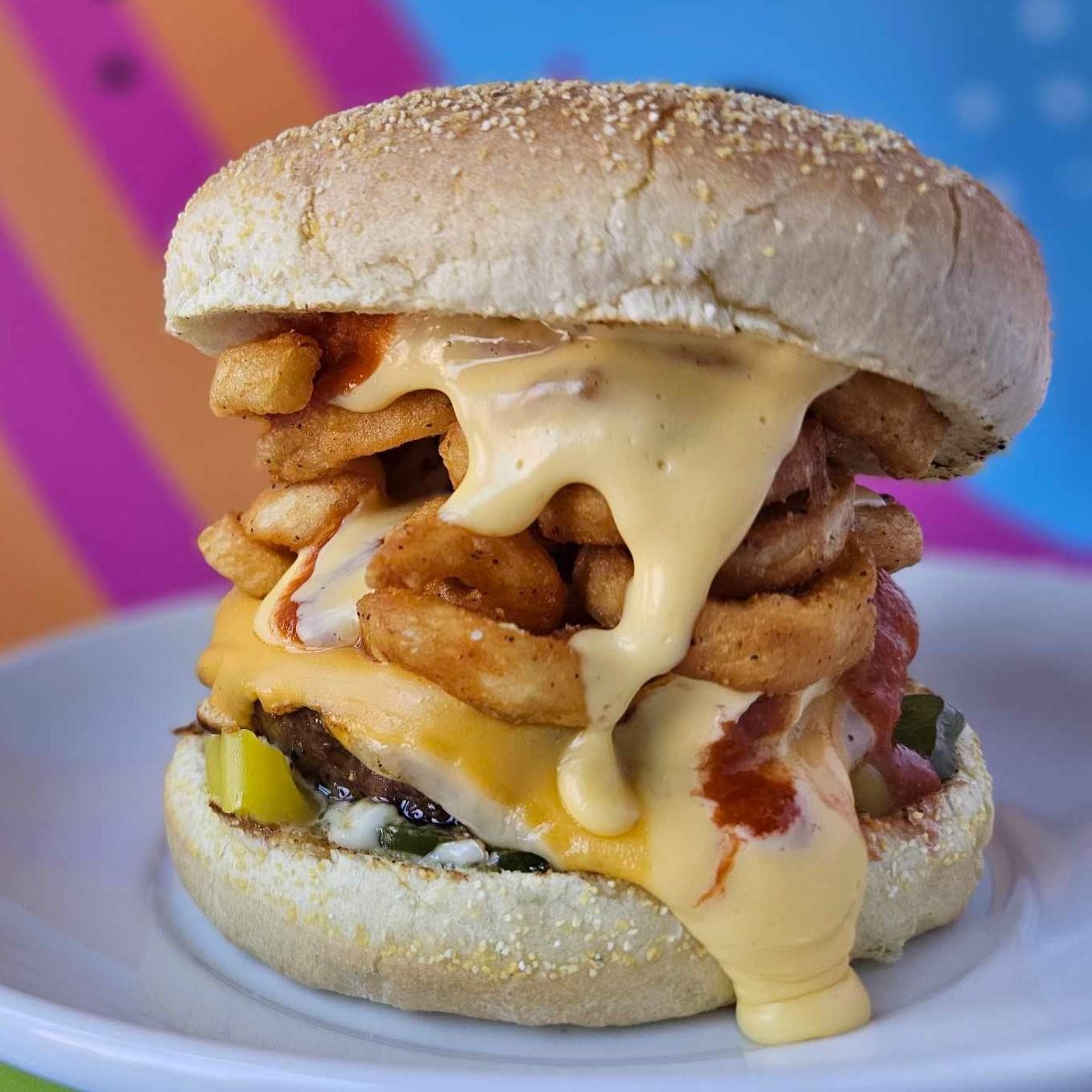 Bowser Burger - Kaiser Roll, Beef Patty, Banana Peppers, Jalapenos, American and Fontina Cheese, Pesto Aioli, Five Years of Fury, Curly Fries, Cheese Sauce