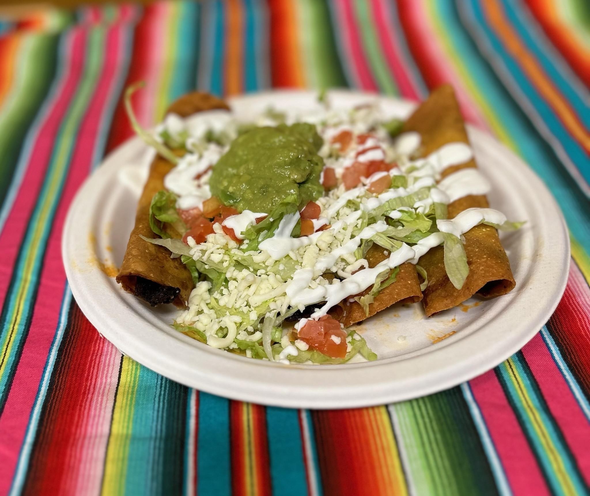 taquitos (lettuce, tomatoes, cheese, sour cream and guacamole)
