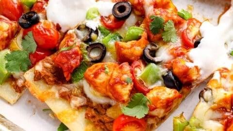 SANTA FE medium salsa, mozzarella, grilled chicken, taco seasoning ~ baked ~ then topped with lettuce, tomato, black olive, cheddar & side of sour cream