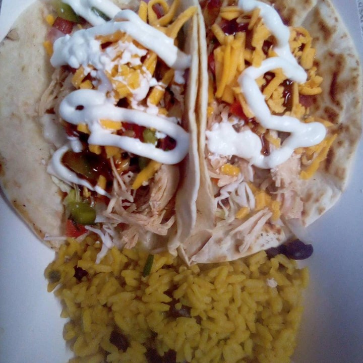  Chicken soft tacos with the side of Spanish rice.