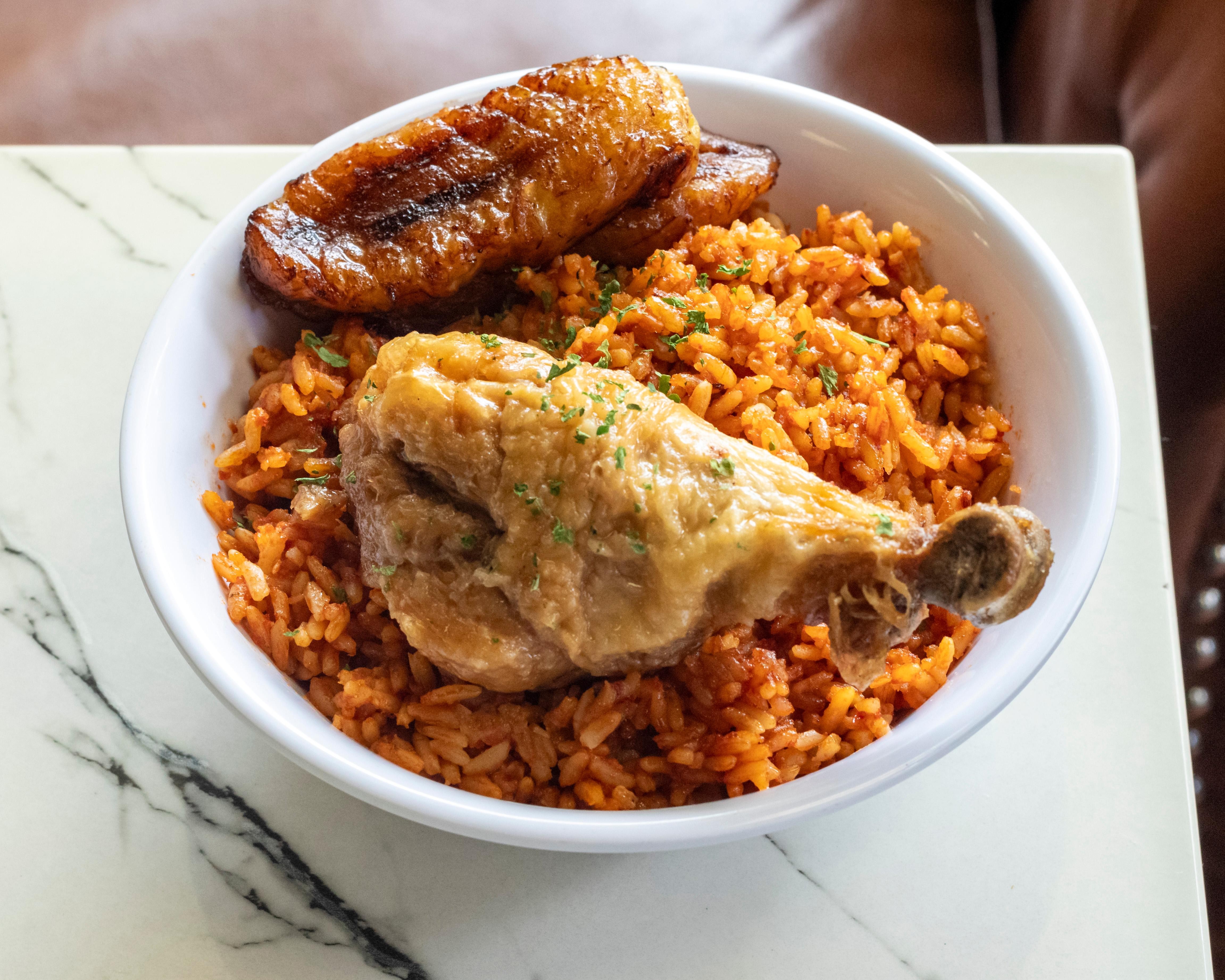 Jollof rice,  (1) psc Chicken drumsticks and (2) slices of plantain