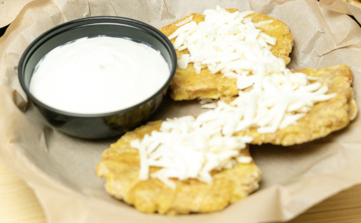 Tostones (3) with grated white cheese and mexican cream