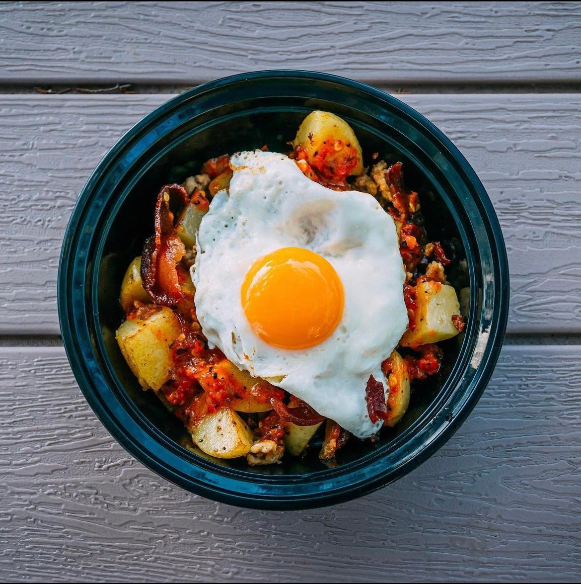 Hash Bowl - Yukon Gold Potatoes, Peppers, Onions, Sausage, Bacon, Sunny Egg, Sweet Heat Sauce