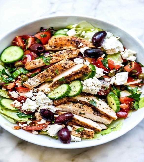 GREEK SALAD WITH GRILLED CHICKEN, ROMAINE LETTUCE,CHERRY TOMATOES, BLACK OLIVES, CARROTS,FETA CHEESE, GARBANZO, CUCUMBER, ITALIAN DRESSING