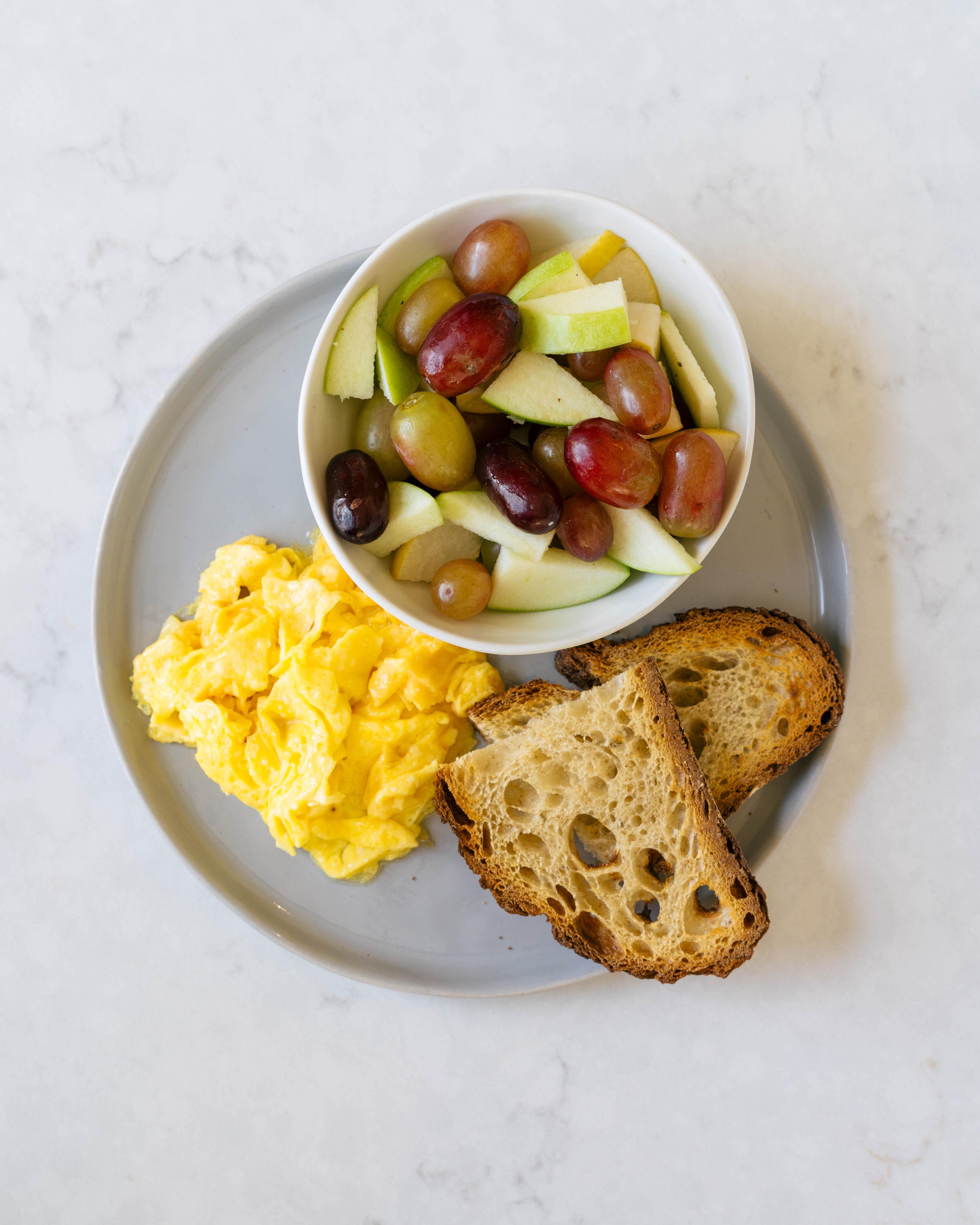 Scrambled egg, toast, and fruit