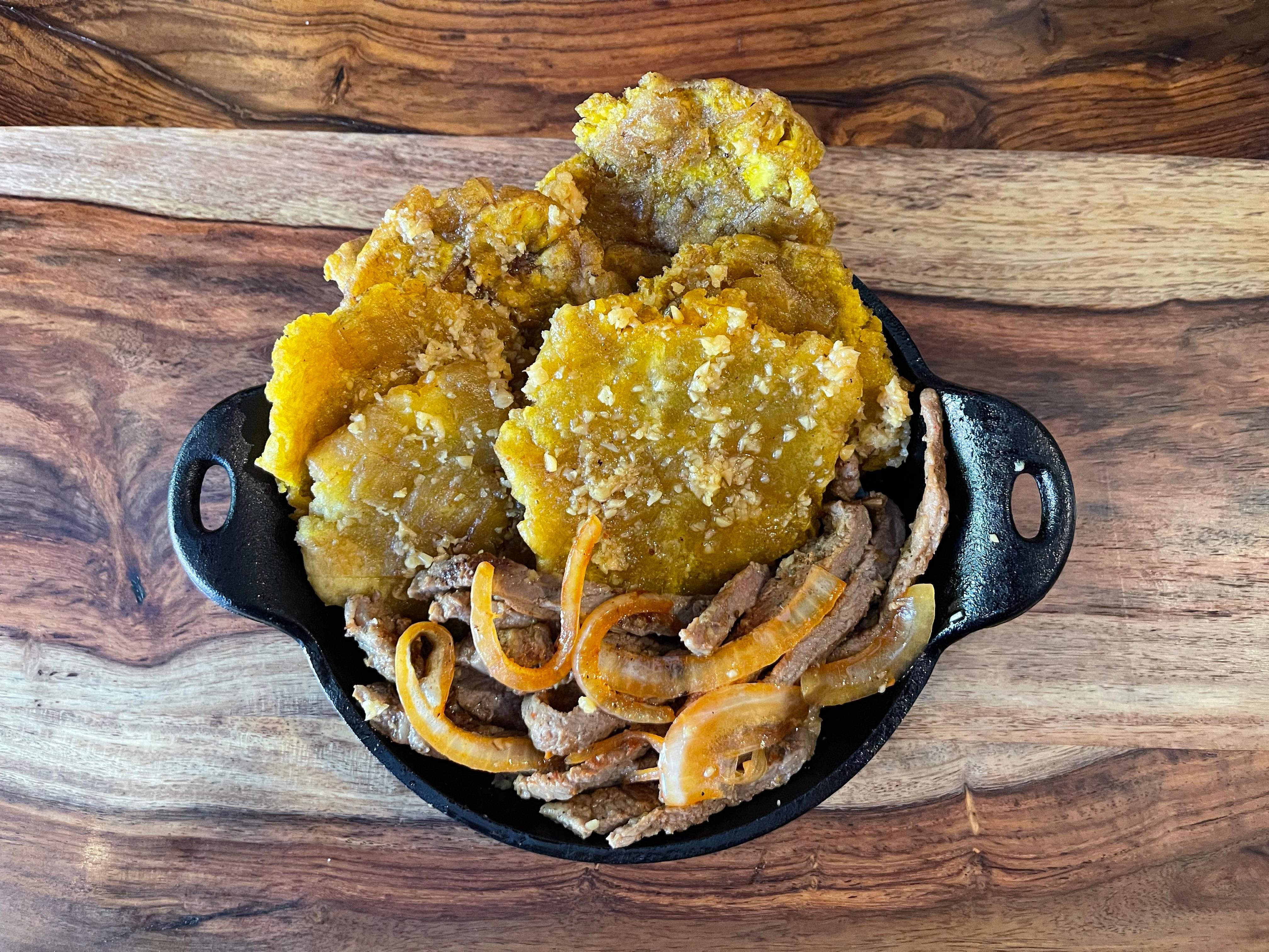 SIZZLING GARLIC INFUSED TOSTONES W/ YOUR CHOICE OF PROTEIN (Green Plantains)