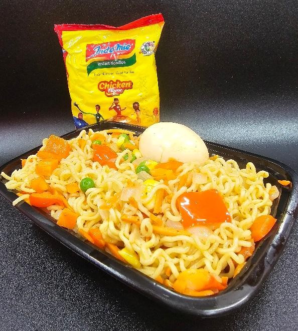 Indomie with chicken and a can of soda