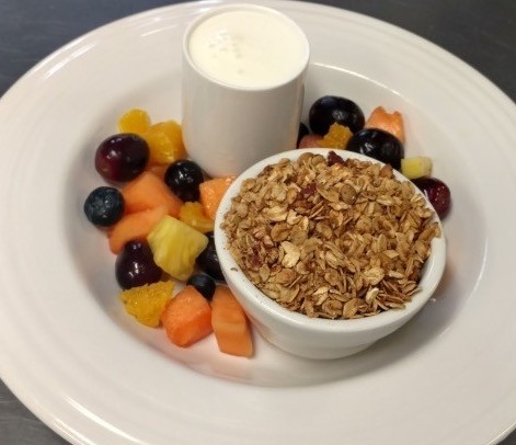 Granola served with fresh fruit and kefir