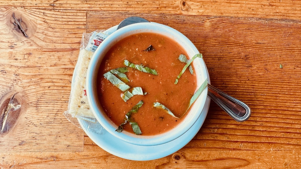 Cup of Creamy Tomato Basil Soup with Cracked Pepper