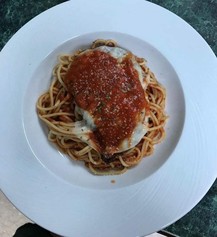 Chicken Parmigiana over spaghetti