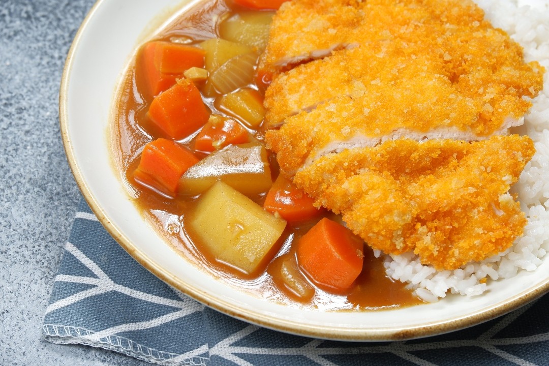 Chicken katsu with yellow curry sauce over rice