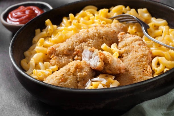 Sauce and Tossed Chicken Tenders over Mac N Cheese: