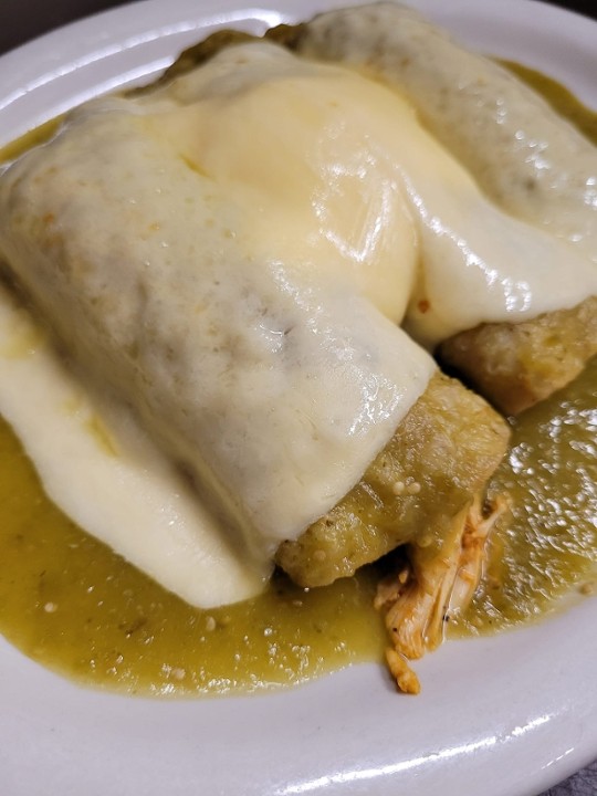 ENCHILADA  DINNER WITH SAUCE, SOUR CREAM AND MELTED CHEESE