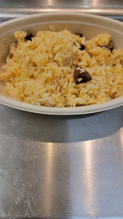 Traditional Spanish rice **contains pork