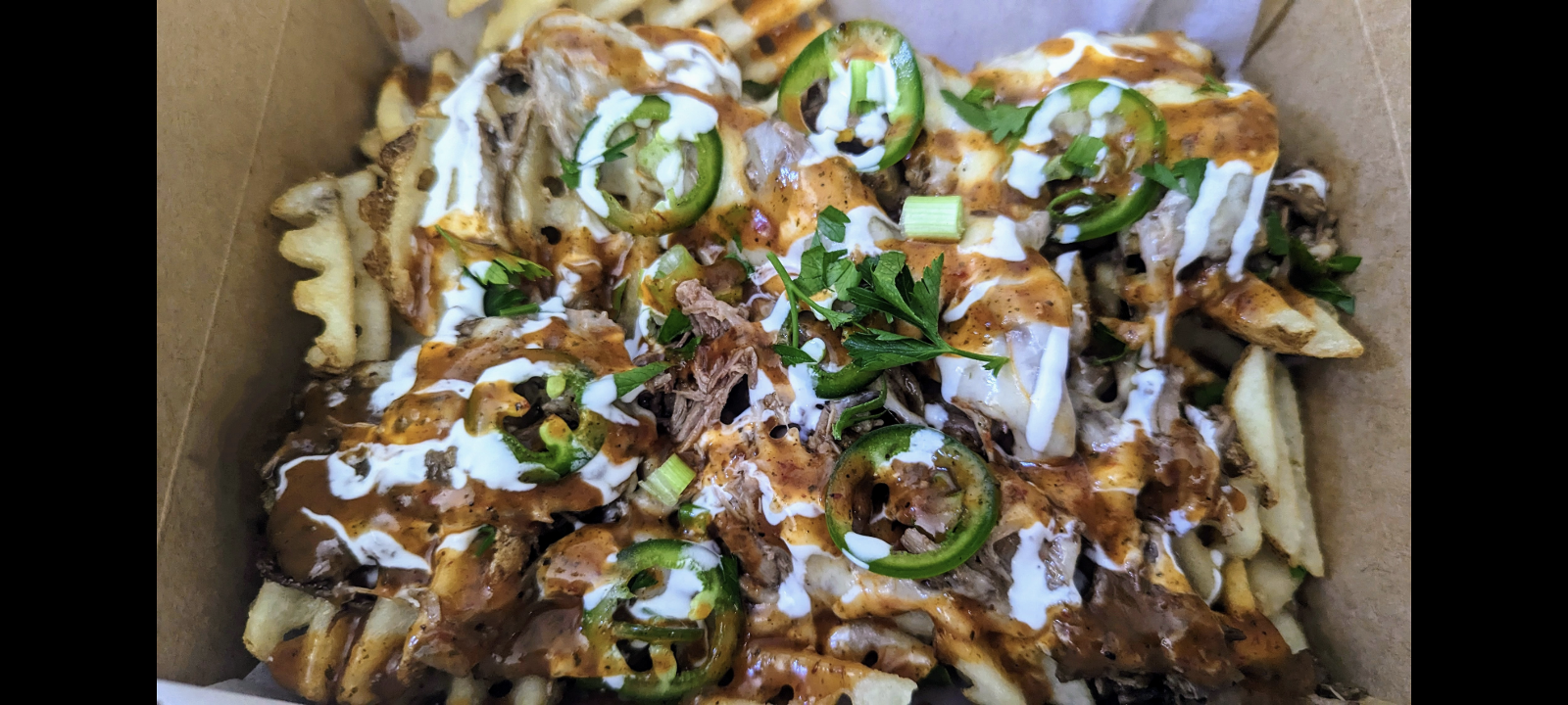 Loaded Freedom Fries (Savory slow cooked beef, Muenster cheese, Green onion, Fresh jalapeno slices, Mexican crema, and our Signature CCV sauce)
