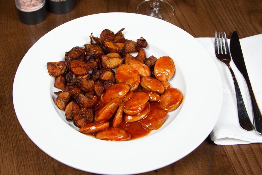 Currywurst desc: two german bratwurst with our homemade currywurst sauce and fried Yukon potatoes