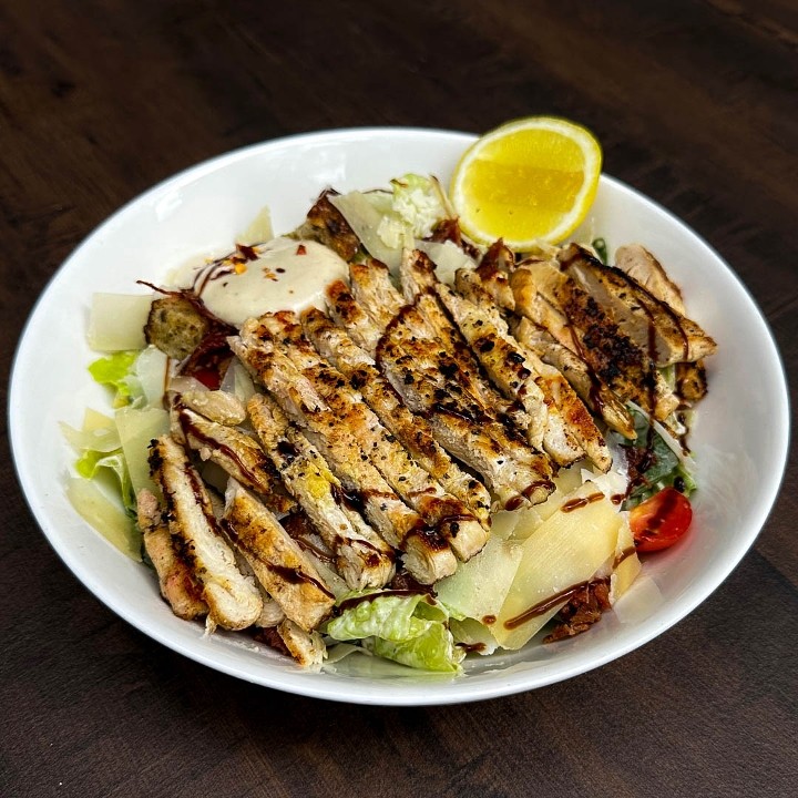 Caesar salad, Grilled Chicken, Romaine Lettuce, Cherry tomatoes, Shaved parmesan, Croutons, Bacon Crumble & Caesar Dressing