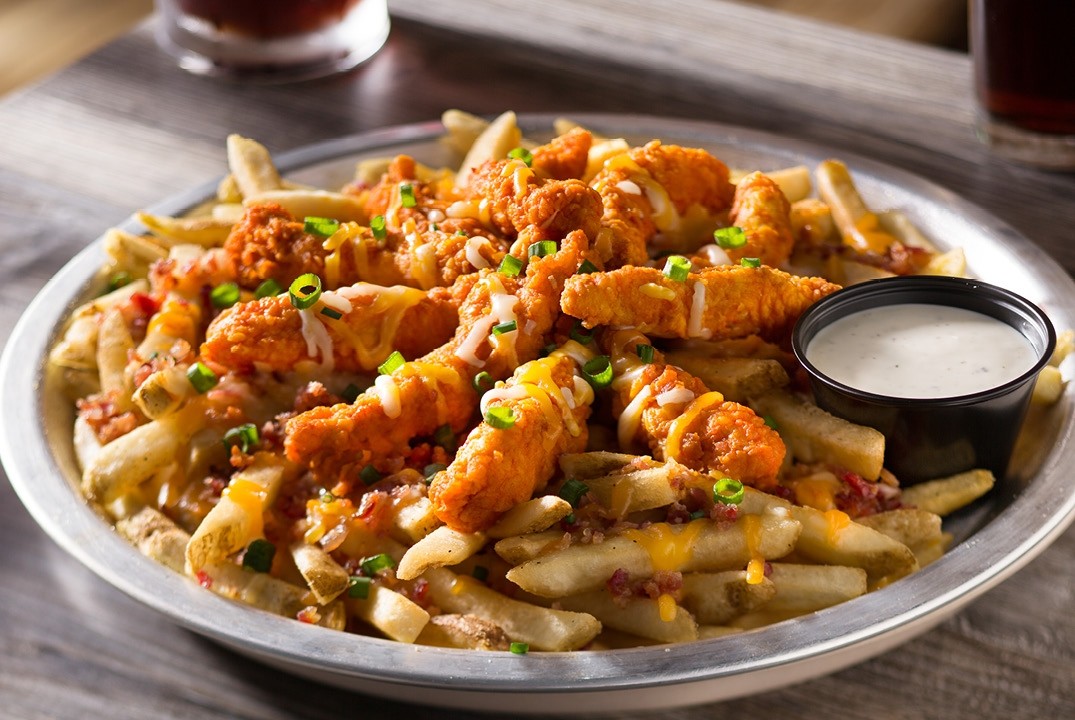 MOUNTAIN MELT Our delicious chicken tenders tossed in your choice of sauce, Mozzarella and cheddar cheeses, bacon on a mountain of fries served with side of sour cream or ranch dipping sauce!