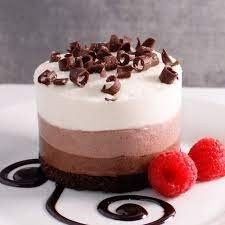 CHOCOLATE TRILOGY  dark, milk & white chocolate mousse atop choclate cake