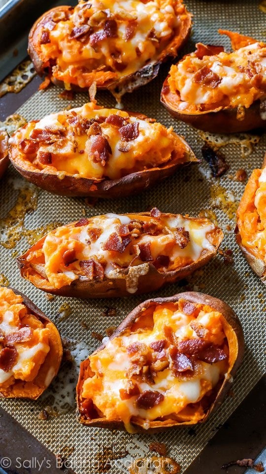 POTATO SKINS brushed with garlic butter, mozzarella, bacon, cheddar & seasoning.  Served with side of sour cream