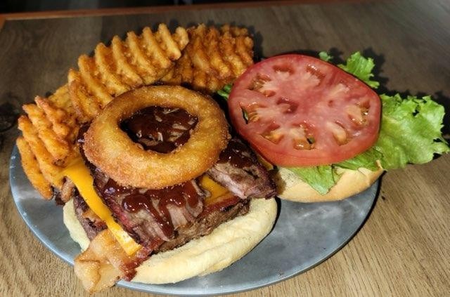 Meat Lover Burger, 1/2lbs burger with Bacon, Cheddar, Brisket, BBQ Sauce, Onion Ring, Lettuce, Tomato & a side of Fries
