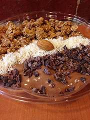 ALMOND JOY BOWL - banana, coconut, raw cacao, house-made almond milk.  Topped with coconut, nibs, and drizzle of honey