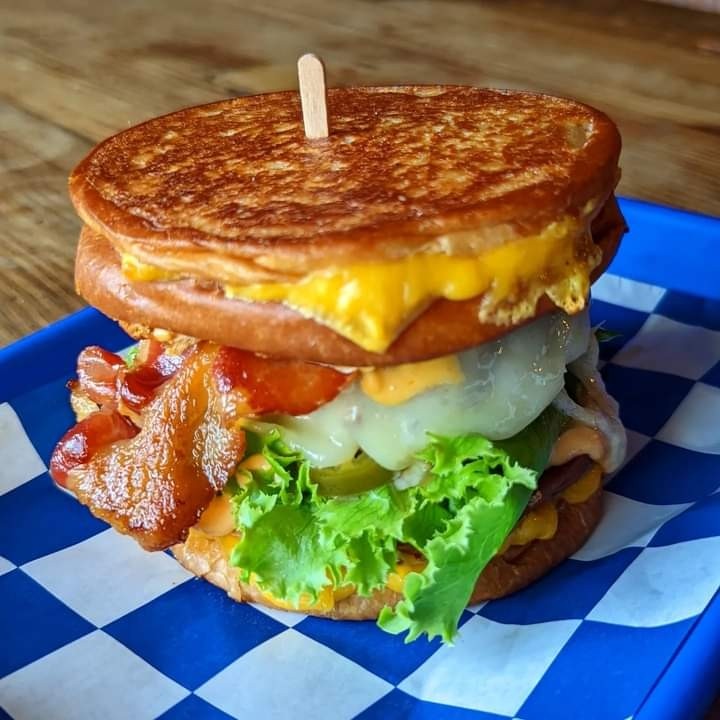 Ocho Cinco Burger, brioche grilled cheese buns, our burger with pepper jack, bacon, jalapenos, lettuce 10k island sauce - August Burger of the Month