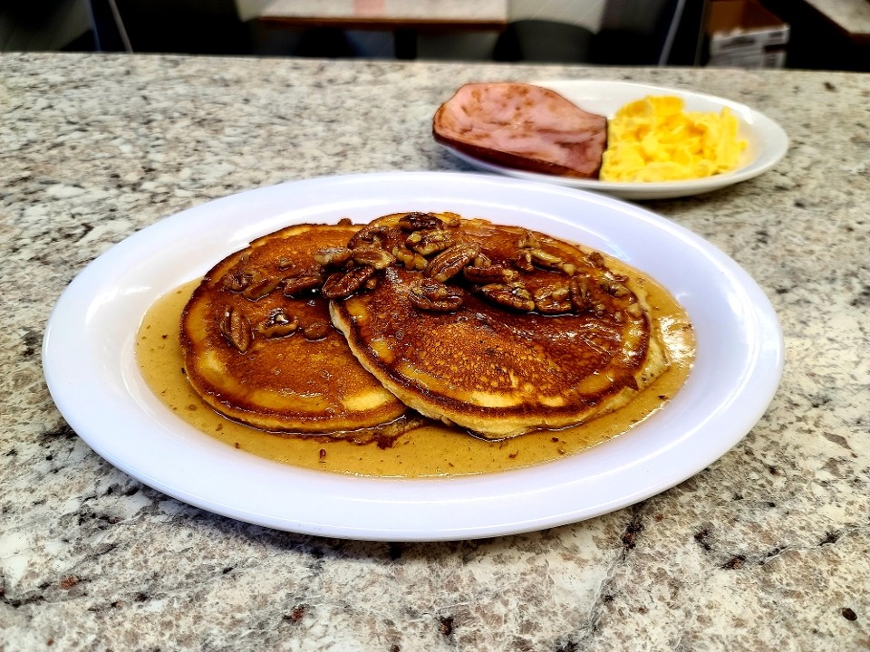 Cornbread Pancakes with butter pecan syup with 2 eggs and ham, bacon or sausage