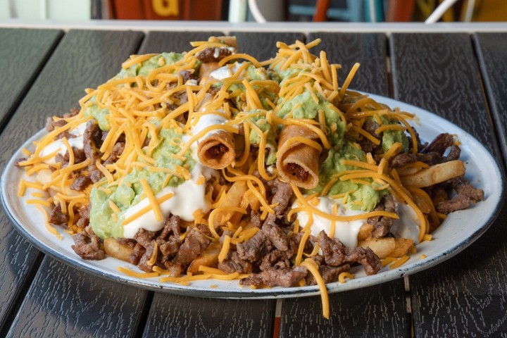 Carne Asada Fries with 2 Rolled Tacos on Top