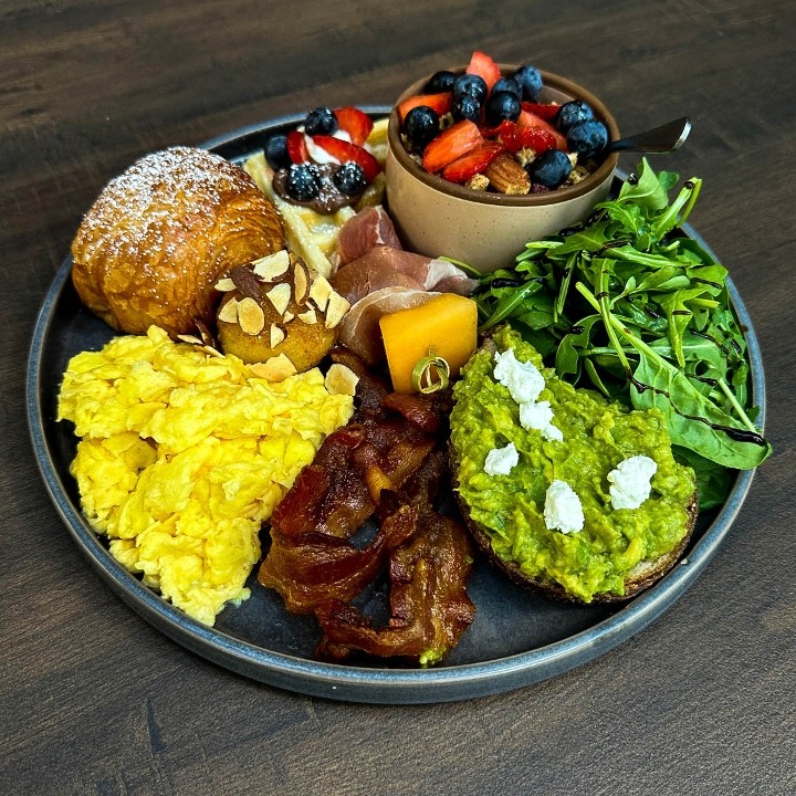 Post-Apocalyptic Brunch Plate: Scrambled/Poached Eggs, Bacon, Mini Choco Croissant, Mini Granola, Mini Waffle, Prosciutto & Melon Bite, Mini Avo-Toast, Goat Cheese Croquette & Green leaves