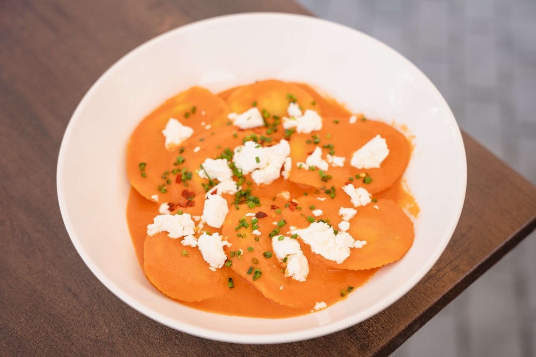 Pumpkin & Mozzarella Sorrentinos: Creamy Tomato Sauce, Goat Cheese, Chives & Chilli Flakes