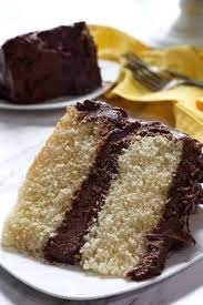 Slice of VEGAN yellow cake w/dark chocolate icing