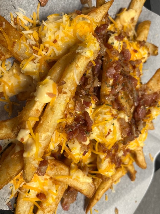 Loaded Beer Fries with Beer cheese sauce, Bacon crumbles & cheddar Jack.