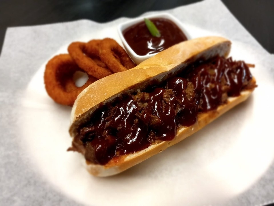 Pulled Brisket with House BBQ sauce on French Baguette w/onion Rings Or Fries