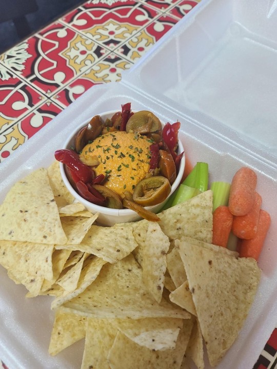 Roasted Red Cherry Pepper Hummus with Veggies and Chips Appetizer.