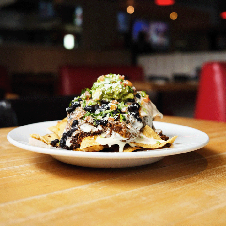 - GREEN CHILE BEEF NACHOS PILED HIGH -