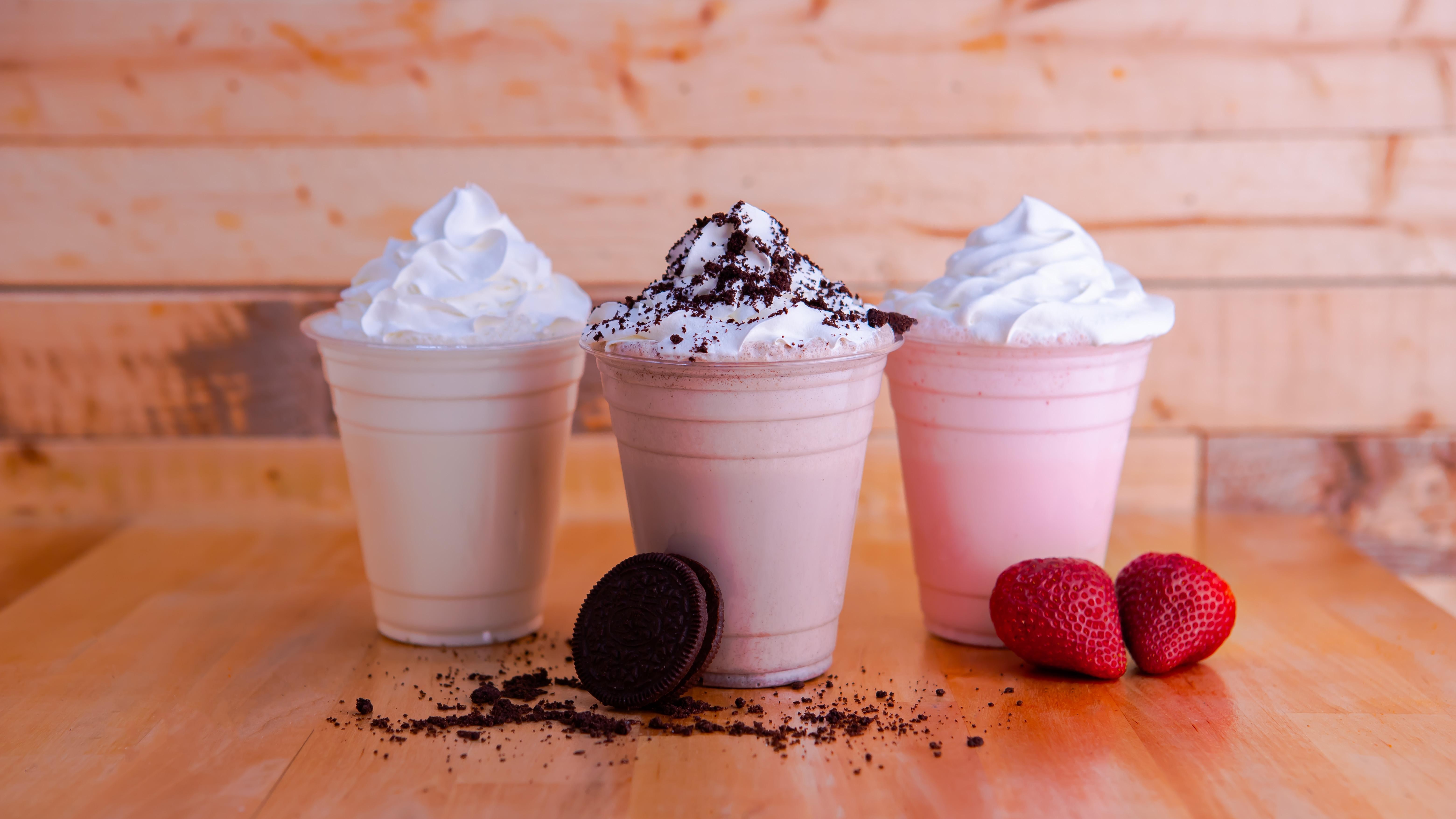 Premium Photo  Milkshake with strawberry pieces, in plastic cup, delicious  and fresh